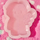 Chucky holding a candy cane mold
