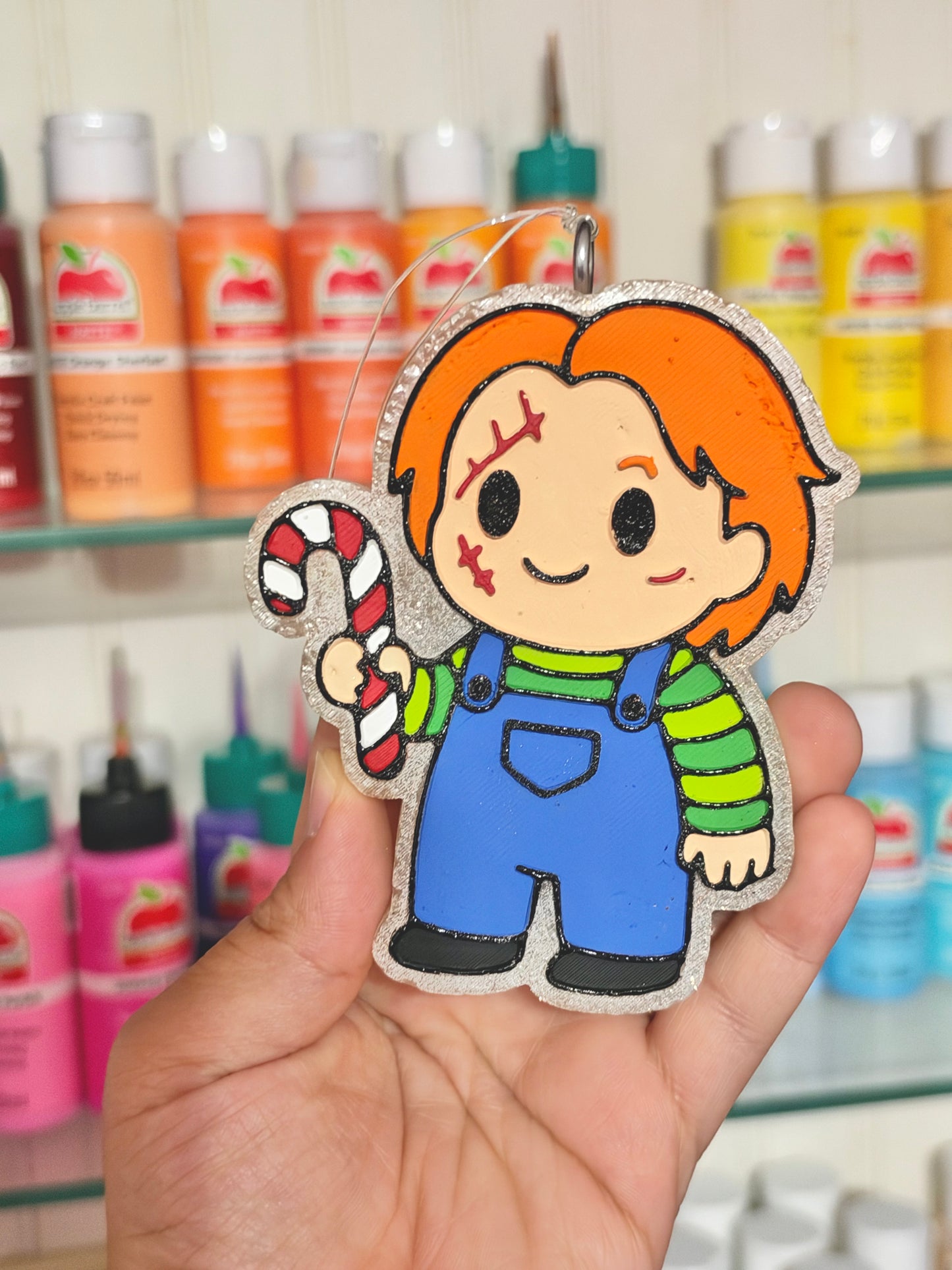 Chucky holding a candy cane freshie